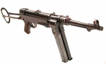 The Legacy of the MP40--Full Auto Review MP40/I Dual magazine release button on the front slides the fresh magazine into position.
