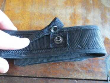 Factor LED Flashlights -- Review The button securely fastens the flashlight holster around your belt.