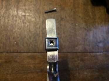 The stirrup, along with the screw, is what affixes the monogrip to the handle. 