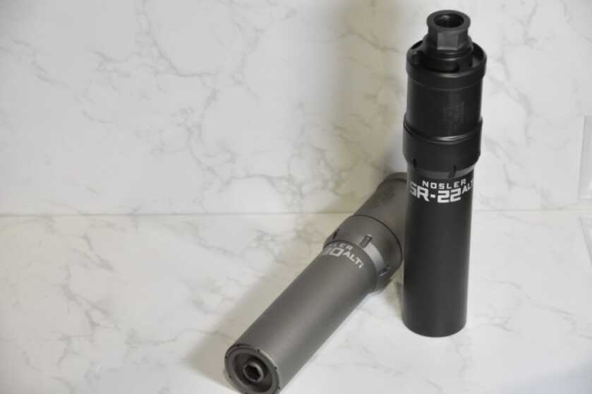 Nosler Goes Quiet with New Suppressors -- SHOT Show 2023 two suppressors on a white backdrop