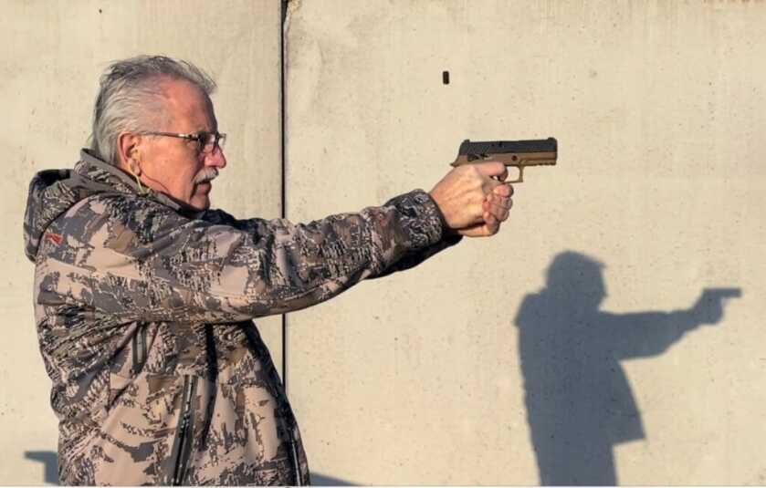 The Stacker: The Next New Thing for Better Pistol Shooting? The authot shooting a pistol with The Stacker installed