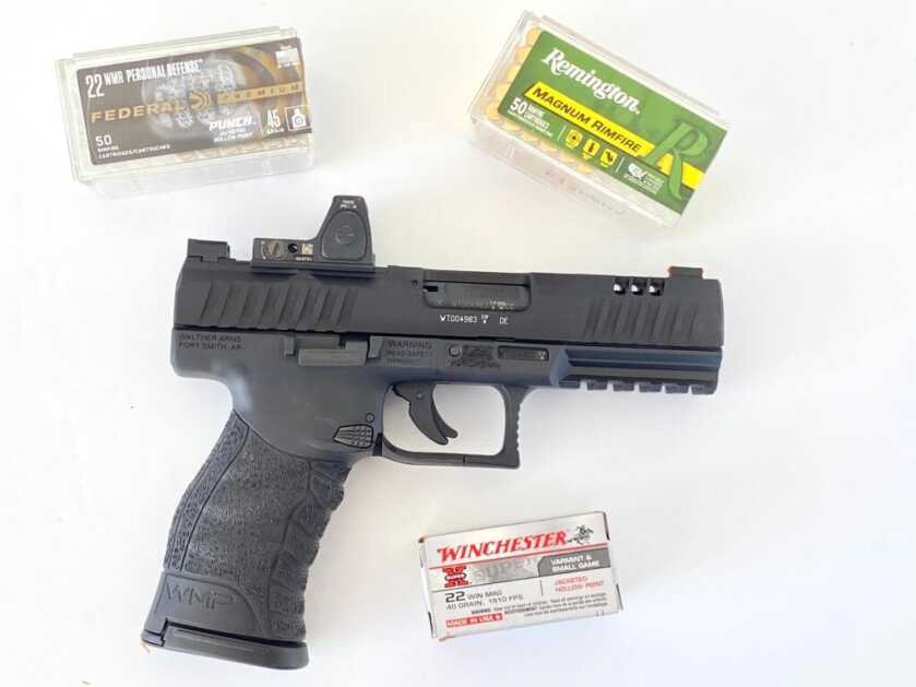 Walther WMP .22 WMR pistol displayed with boxes of Winchester, Federal, and Remington ammunition