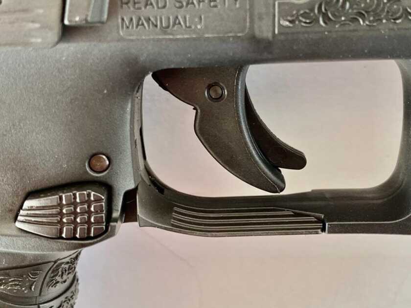 Close-up of the Walther WMP bladed trigger, ambidextrous button release, and paddle magazine release