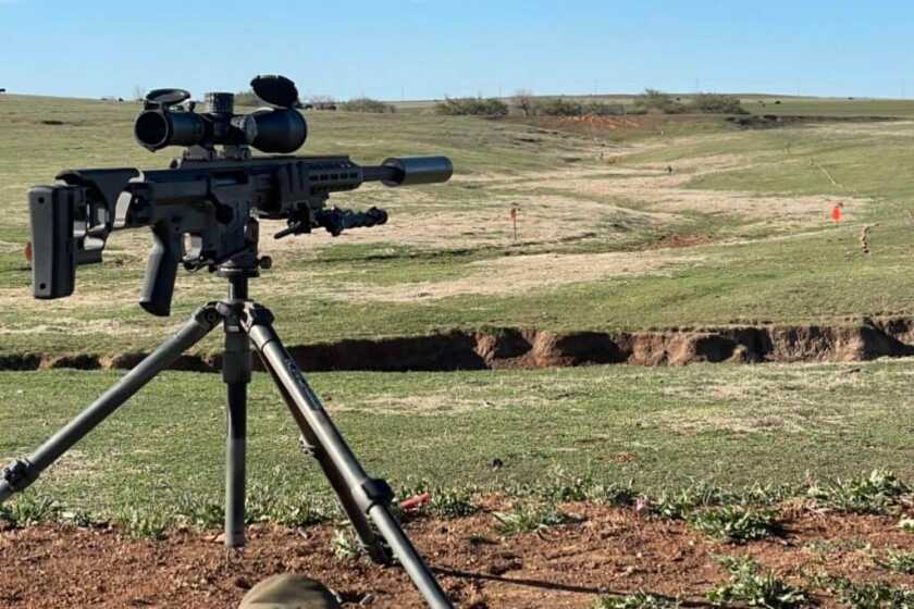 Barrett MRAD: SOCOM's Chosen Precision Rifle - A Comprehensive Review Barrett MRAD sitting in a Kopfjager K800 tripod overlooking a pile of Ta Targets silhouettes at varying distances