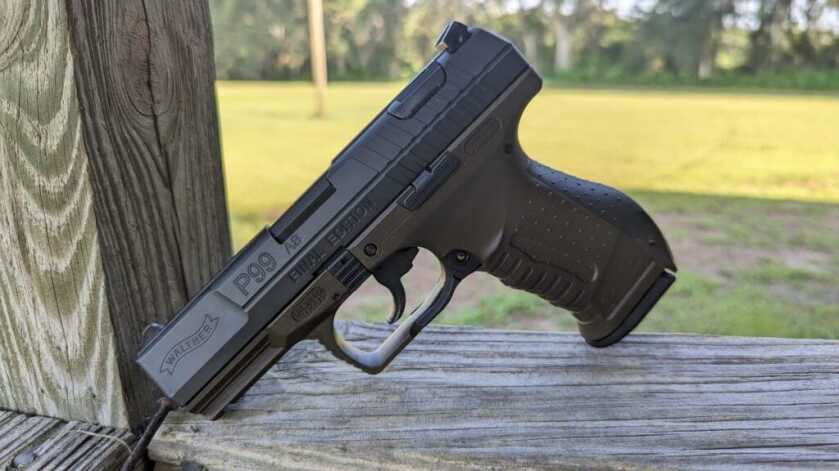 2 - The Walther P99 - Final Edition Beautiful Final Edition handgun sitting on wood beam outside in front of grassy space
