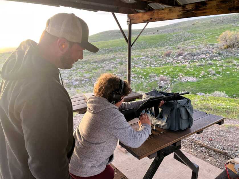 POF Tombstone 9mm with a young boy working the action on a bench rest