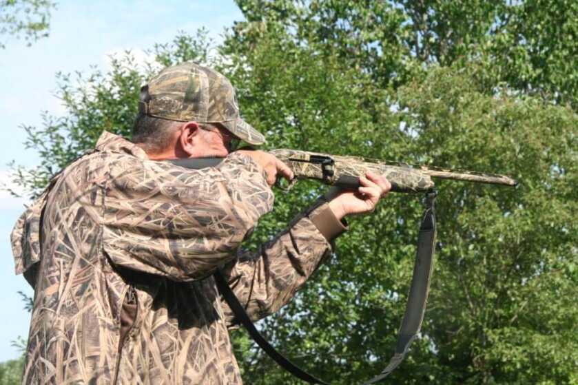 Down Gauging: The Beretta A-400 Extreme Plus Semi-Automatic 20-Gauge Hunter in camo shirt and hat aiming the Beretta A-400
