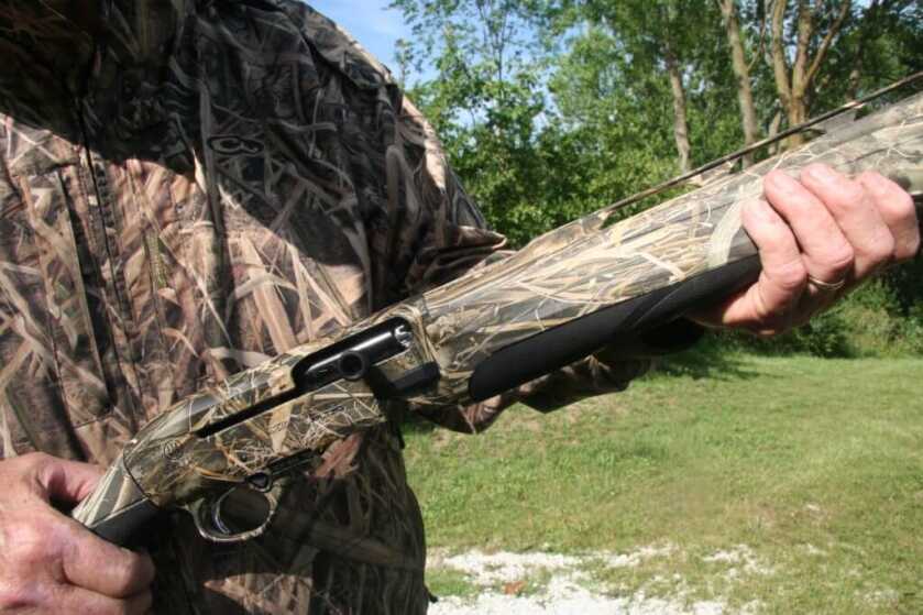 Down Gauging: The Beretta A-400 Extreme Plus Semi-Automatic 20-Gauge Hunter holding the Beretta A-400 and giving a close-up on the charging handle