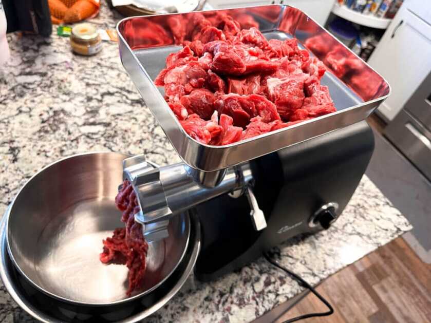 3 - Hunt 365 - Simple Gourmet: Badger Potstickers & Badger Hunting Badger meat going into a Chard meat grinder