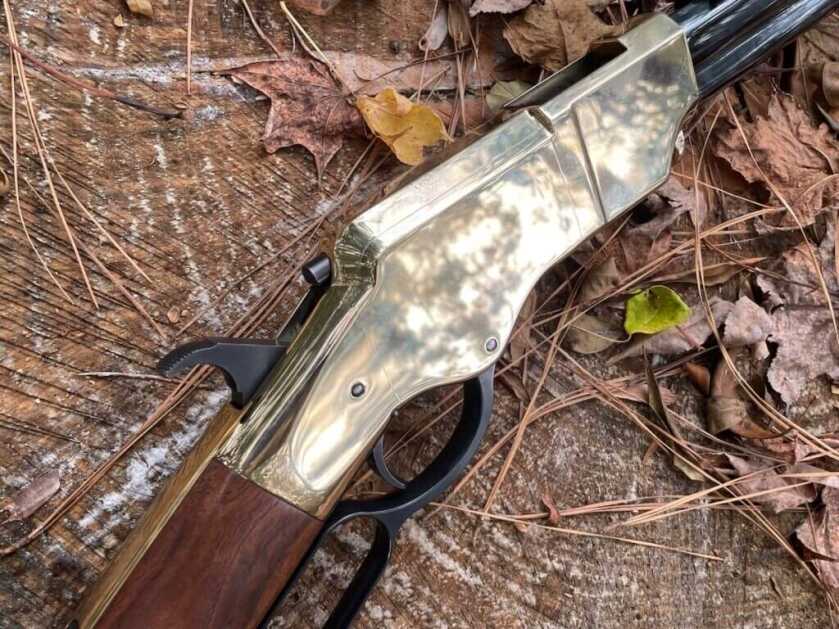 3 - Hunt365 - The New Original Henry In Hunt Camp The New Original Henry rifle brass receiver against a backdrop of leaves and pine needles