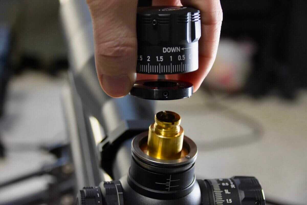 Sightron SVIII The internal mechanics of a rifle scope turret are being displayed.