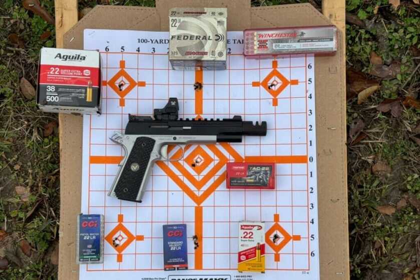 Vudoo Gun Works Target 22LR 1911: Full Review Each box of ammunition placed next to the 5-round group I got shooting from 10 yards. Top and bottom middle groups have a piece of mud I used as a reference point, those are not holes.
