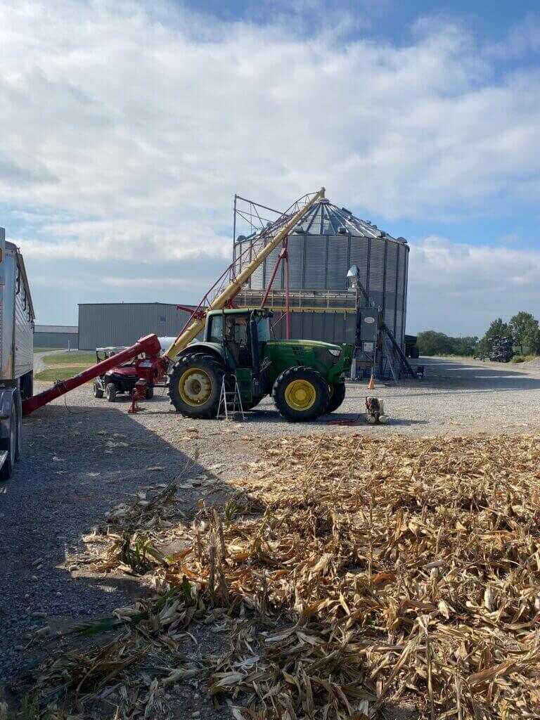 grain bins and tractor on a working farm showing the scale behind duck hunting field permission