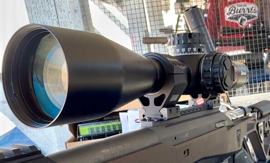 Looking at the objective lens of a modern rifle scope.