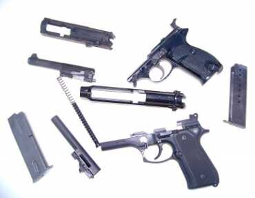 The Walther P 1, top, features WC Wolff recoil springs and has a new locking wedge. It is field stripped along with the very similar Beretta 92. 