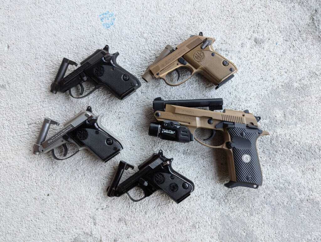 a collection of guns with tipped up barrels