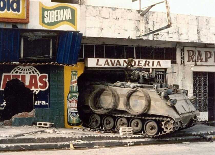 M113 armored personnel carrier drives through a storefront during Panama invasion