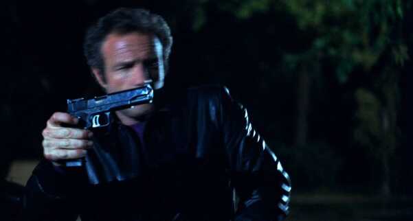 James Caan in thief holding pistol