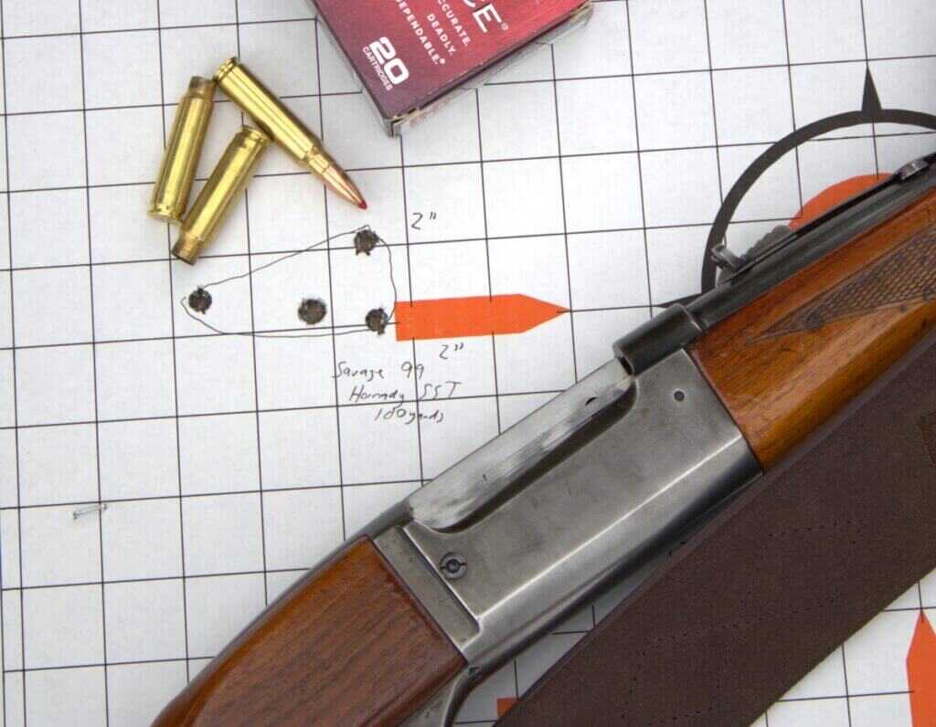 rifle on paper target next to a few rounds of ammo