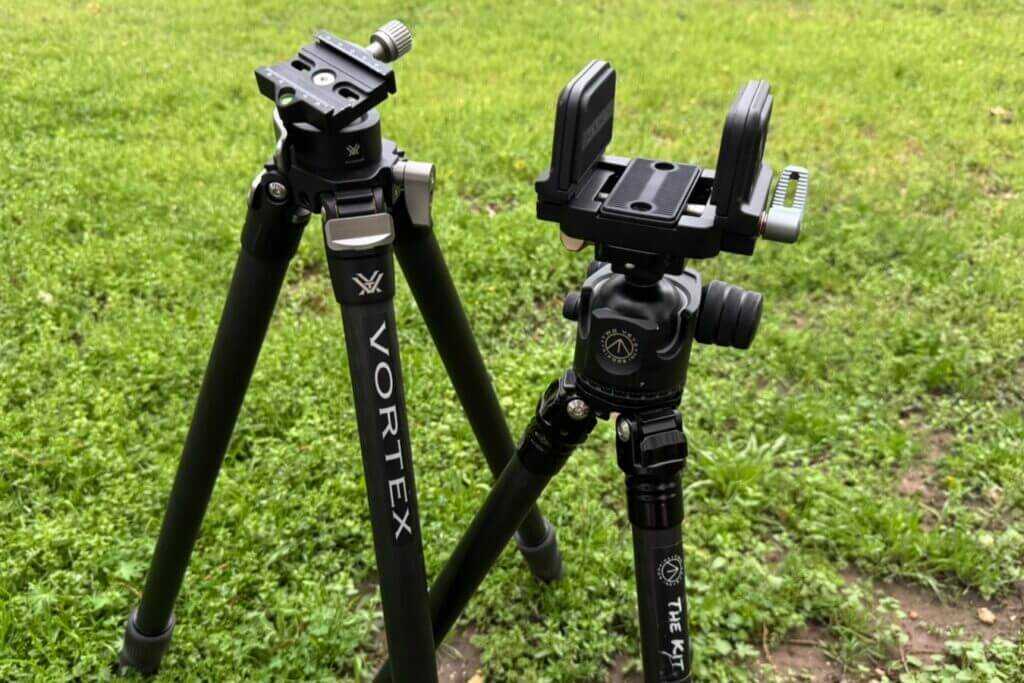 Two tripods sitting on grassy lawn