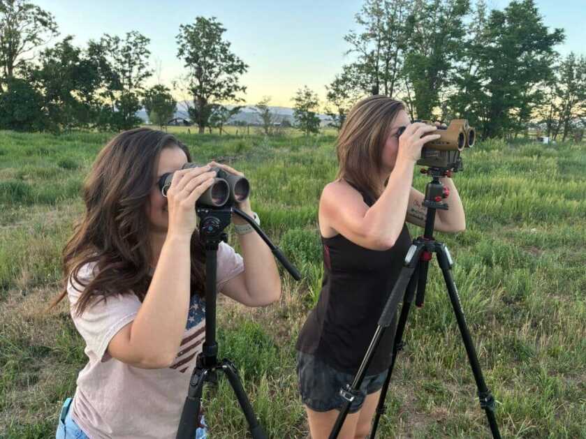 women lookng through binoculars
