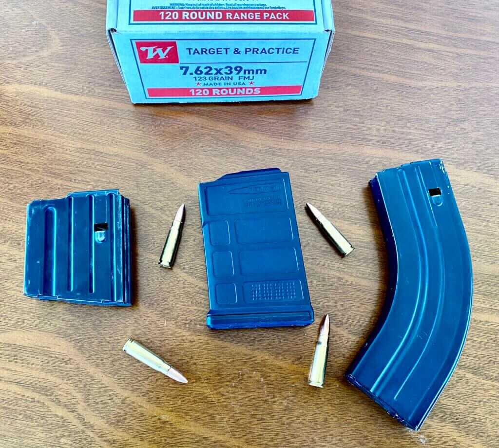 three different rifle magazines with some ammo