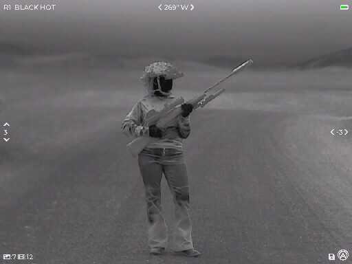 thermal image of a woman holding a rifle 