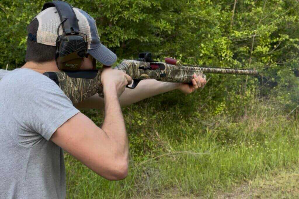 man shooting a shotgun