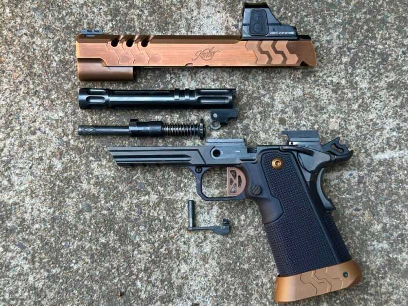 A 2011 pistol is disassembled on a concrete pad. 2K11 Target (OR)
