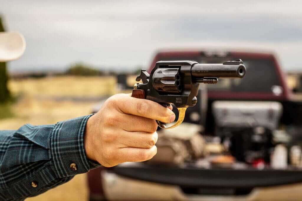 man shooting revolver