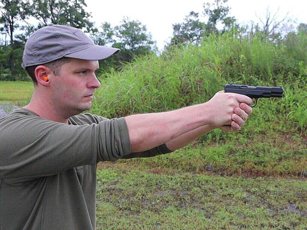 man shooting a pistol
