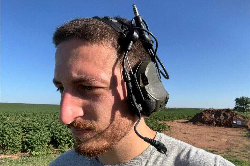 Range montage wearing ComTac VIII during live fire drills demonstrating situational awareness and hearing protection