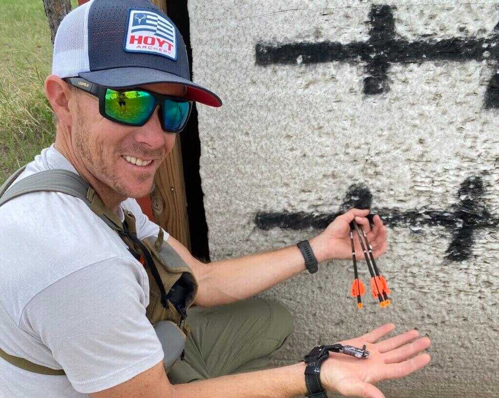 man with target and arrows. index-finger release