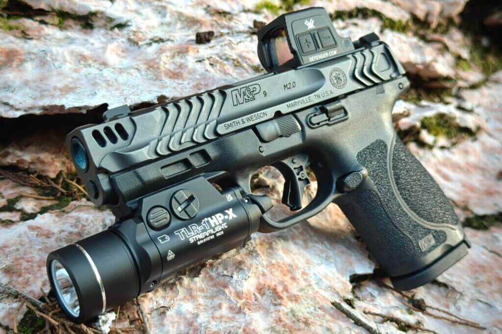 Streamlight TLR-1 HP-X mounted pistol outdoors on rock during range eval