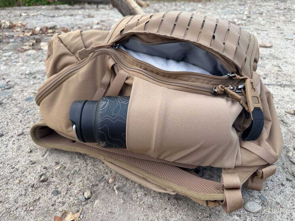 Vertx Siege 25L Tactical Backpack side pocket holding a large water bottle