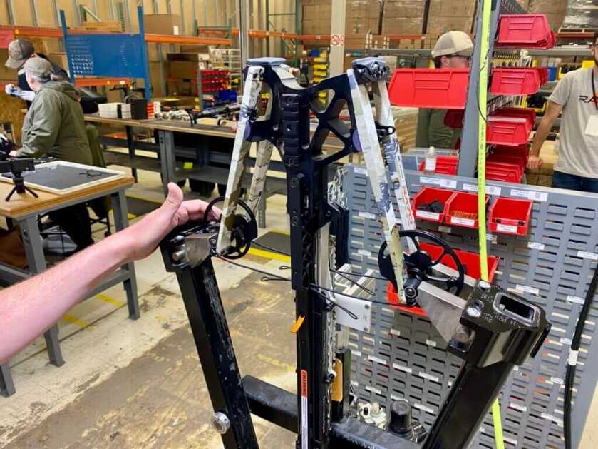 Ravin R470 being strung with HeliCoil system showing cable routing