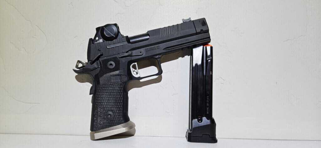 Sig Sauer P211 GTO 2011 pistol with ROMEOX Pro red dot and 23 round magazine on table