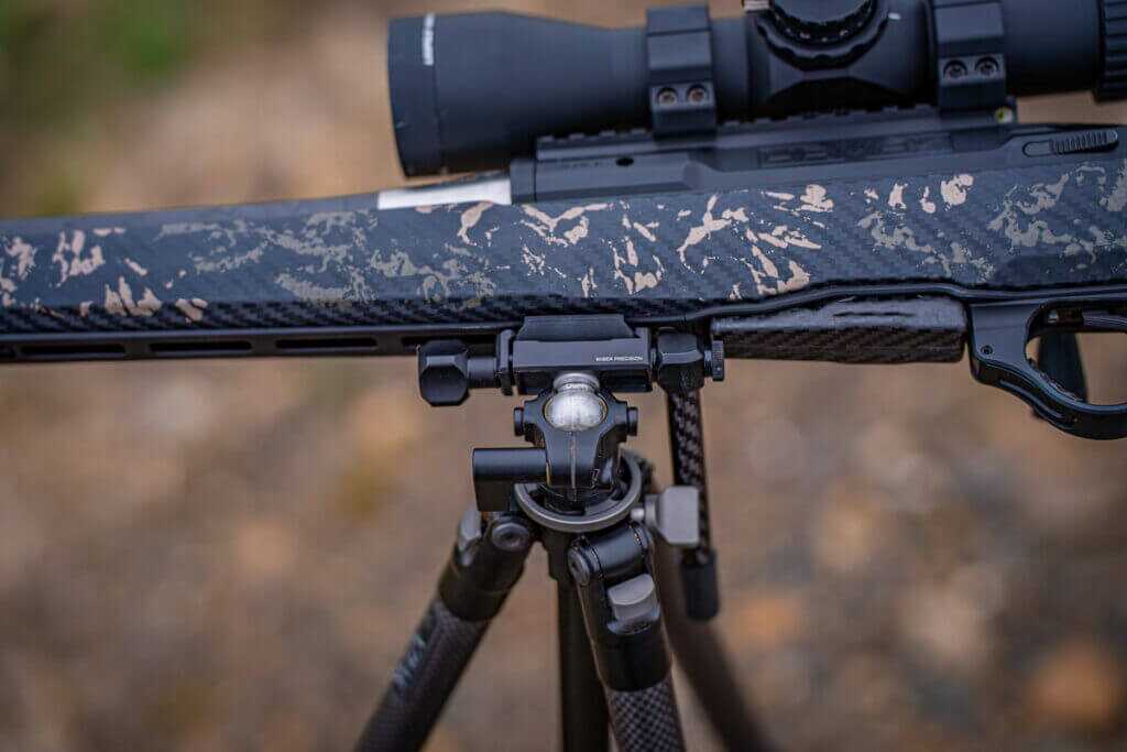 Ridge Warden head in ball mode leveling a rifle on uneven terrain with sideways ARCA rail