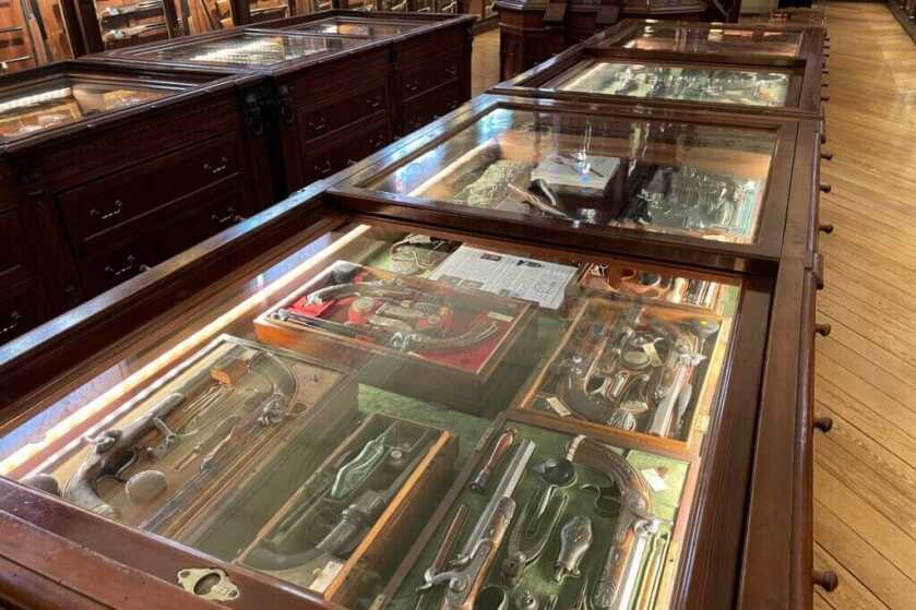 Beretta gun cabinets packed with historic pistols rifles and pull out drawers