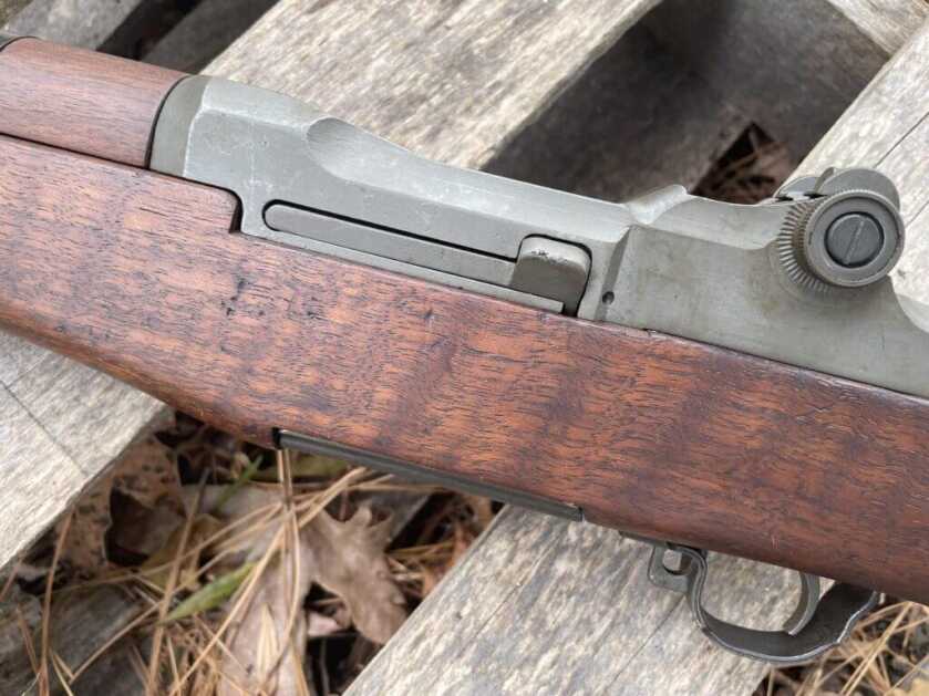 Left side of M1 Garand showing clip eject button with bolt locked back