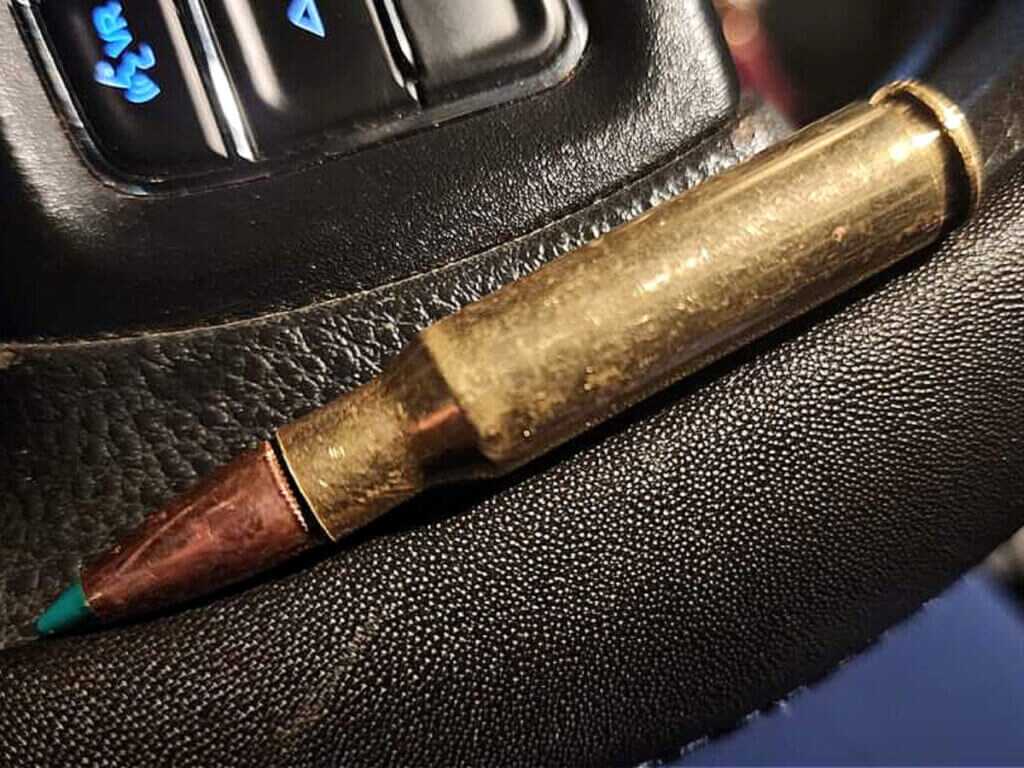 complete round of ammunition with green tip bullet and brass case