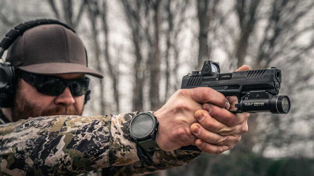 Taurus TX9 on plate rack range session, weapon light attached