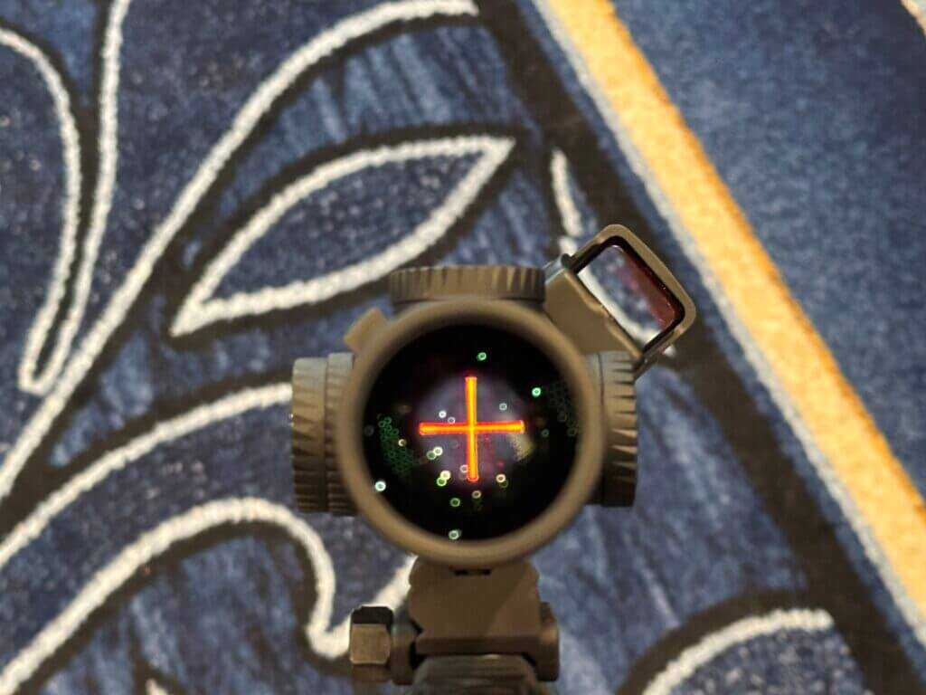 Looking through an optic with an illuminated reticle.