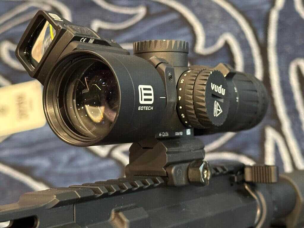 Looking at the objective lens of the optic, there is a red dot-sight mounted above the scope at a 45 degree offset.