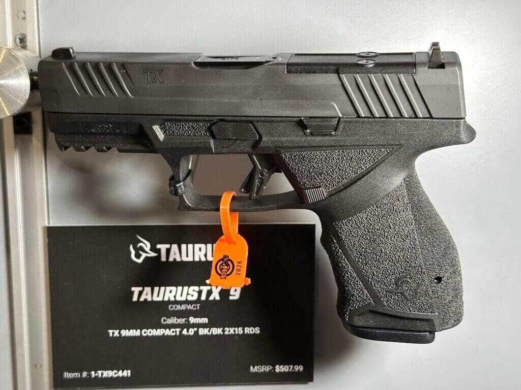 A black pistol faces the left and has a blacard with details behind it.