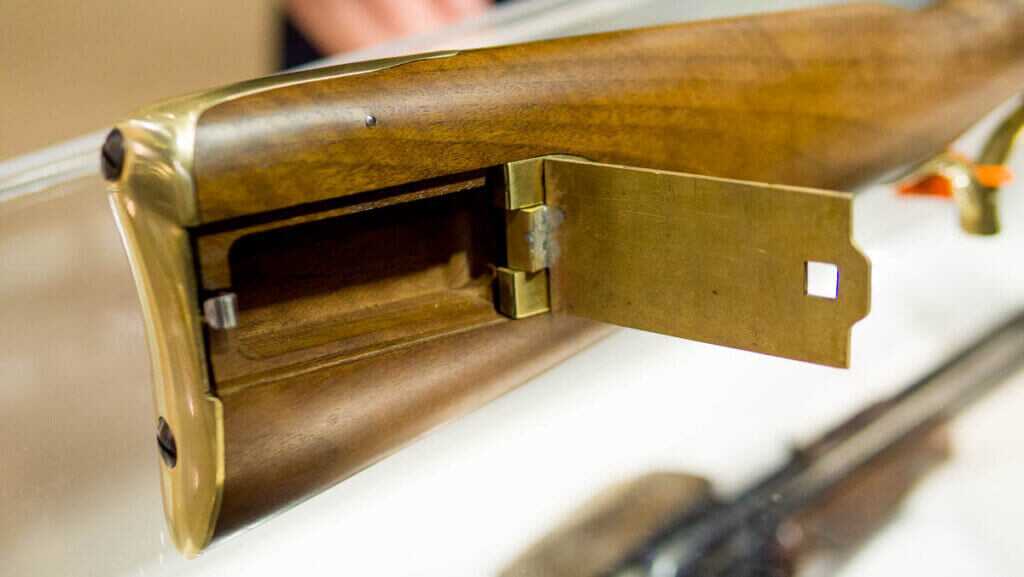 Close up view of the butt stock with open patch storage compartment.