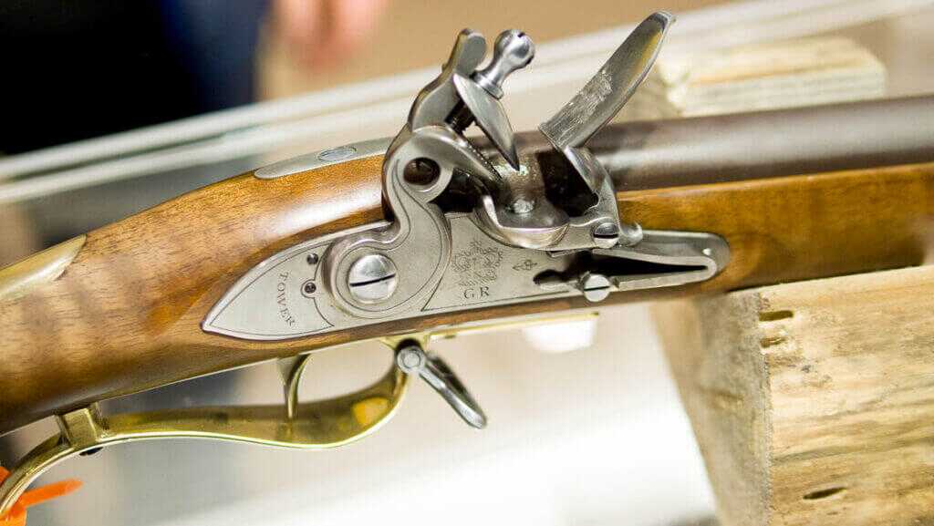 Close up view of the lock with the gun pointed right and the trigger guard visible below.