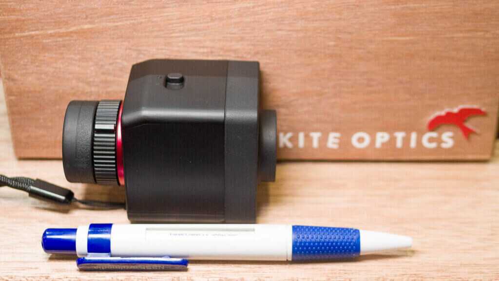 The monocular on a shelf next to a pen for scale.