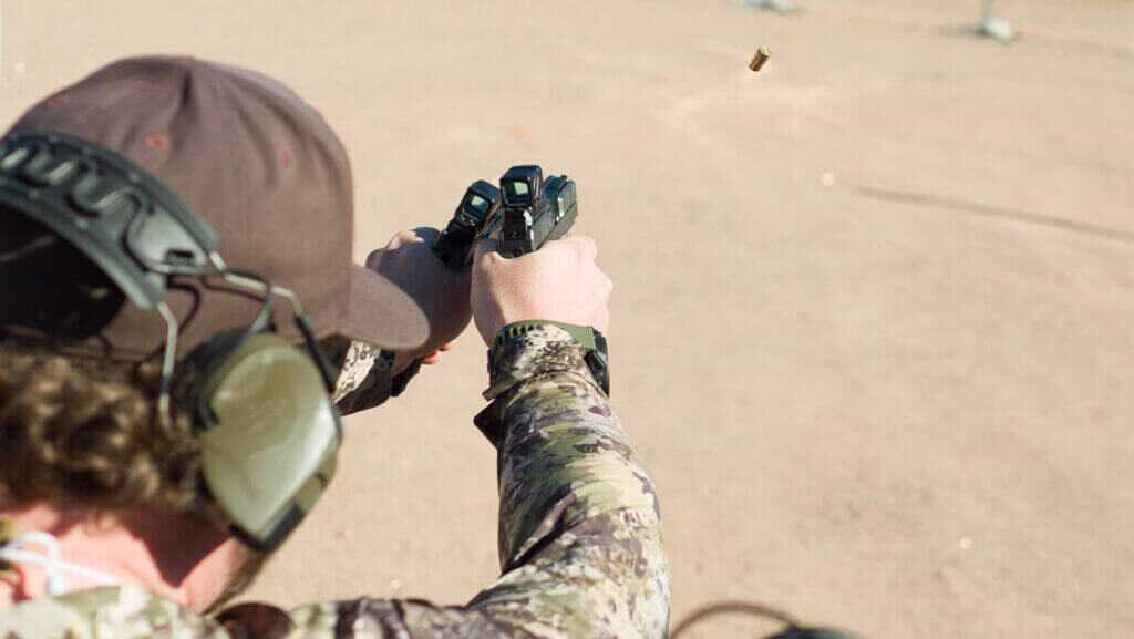shooter at the range shooting with both left and right-handed guns.