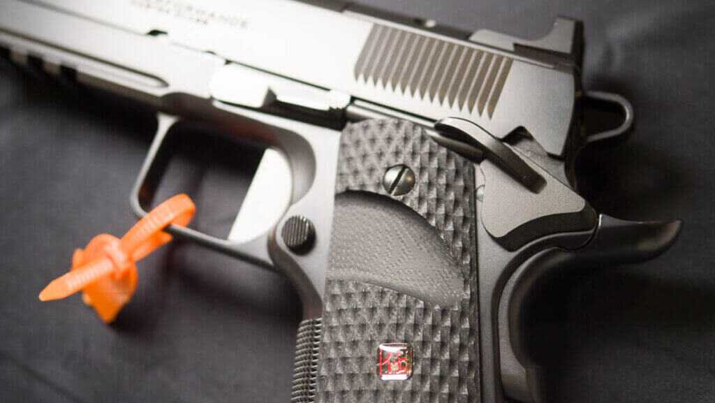 Close up view of the rear left side of the gun on a table.